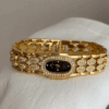 oval_dial_gold_bracelet_watch.gif Elegant Gold Bangle Watch ?C Black Mother of Pearl Oval Dial for Women